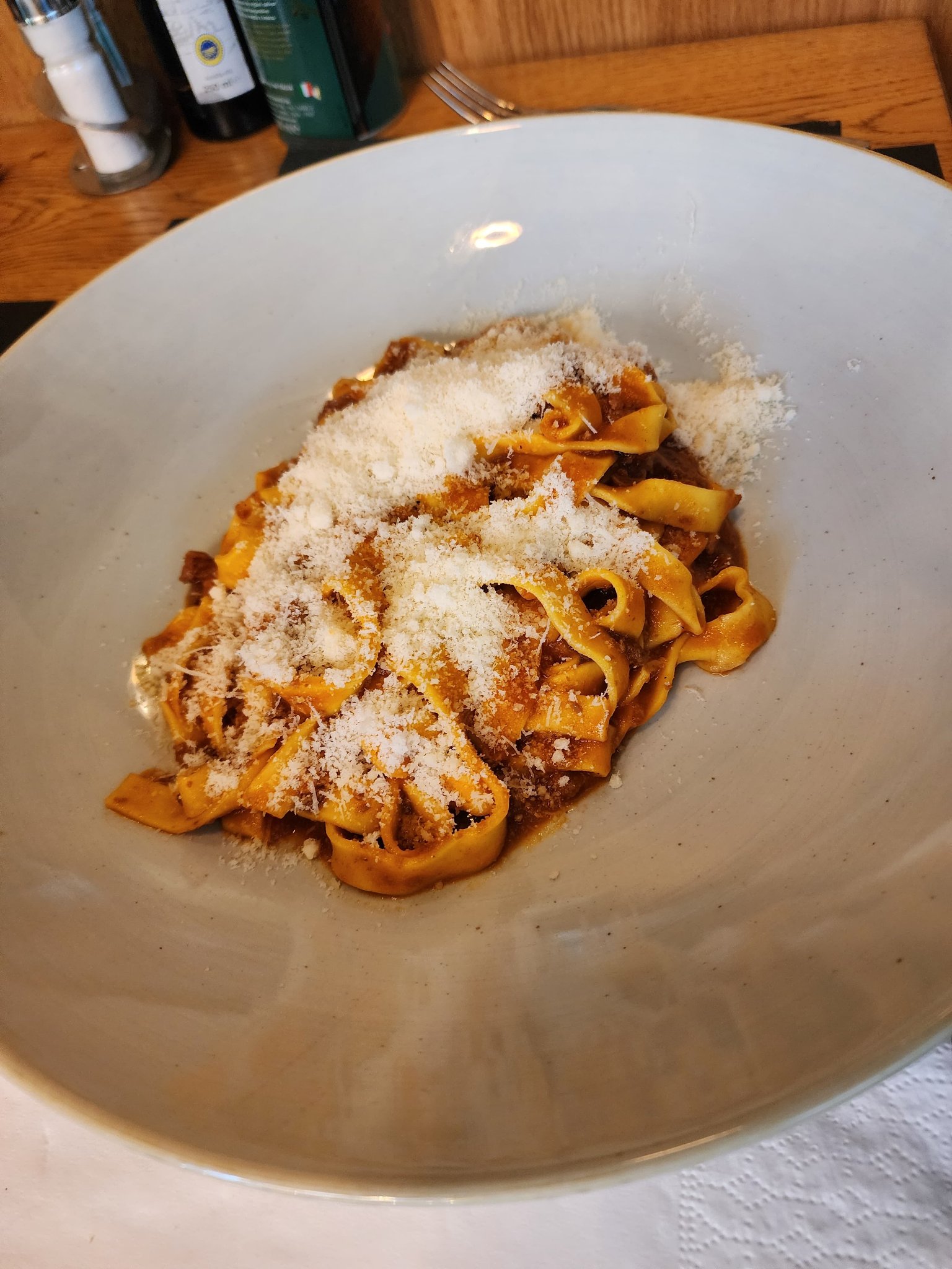 Tagliatelle coated in slow-simmered meat ragù and freshly grated parmesan
